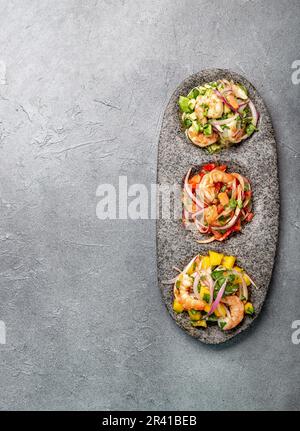 CEVICHE. Three colorful shrimps ceviche with mango, avocado and tomatoes. Latin American Mexican Peruvian Ecuadorian food. Serve Stock Photo