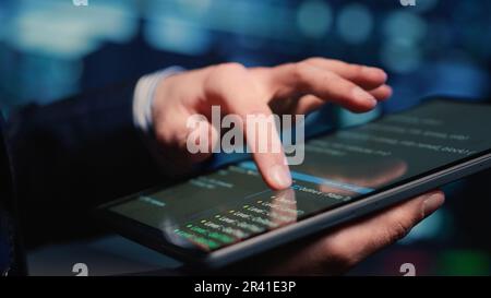 Male system administrator inspecting big data on tablet Stock Photo