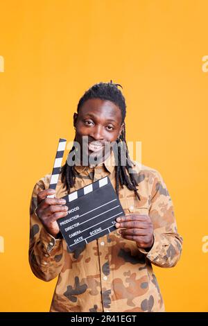 Man holding movie clapperboard Stock Photo
