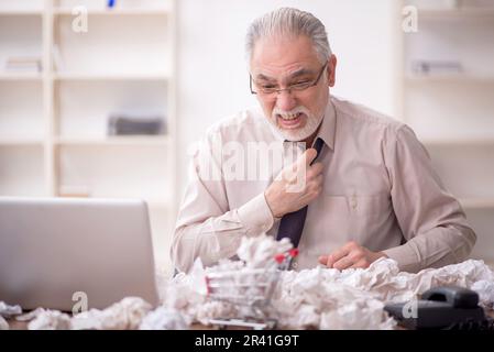 Old male employee in brainstorming concept Stock Photo