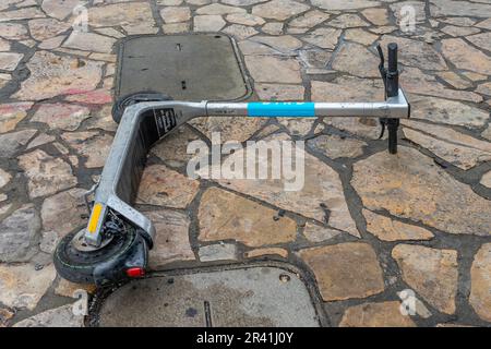 San Antonio, Texas, USA – May 8, 2023: A Bird electric rental scooter left abandoned on the ground at The Alamo Plaza in San Antonio, Texas. Stock Photo