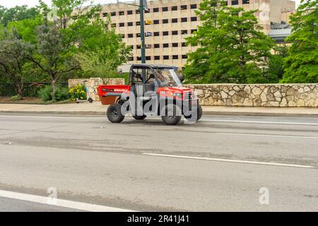 San Antonio, Texas, USA – May 9, 2023: A red Gravely Atlas 3400 side-by-side utility truck traveling on a downtown street in San Antonio, Texas. Stock Photo