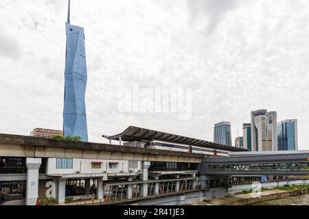 Metro train of LRT Kelana Jaya Line at Pasar Seni stop and skyscraper Merdeka PNB 118 Tower in Kuala Lumpur, Malaysia Stock Photo