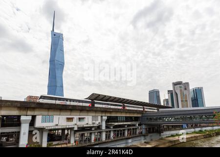 Metro train of LRT Kelana Jaya Line at Pasar Seni stop and skyscraper Merdeka PNB 118 Tower in Kuala Lumpur, Malaysia Stock Photo