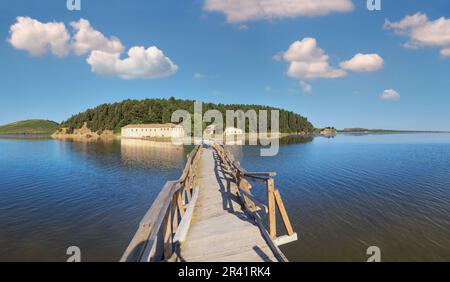 Wooden ruined bridge to isolated Monastery of Saint Mary on Zvernec island (Narta Lagoon, Vlore, Albania). Stock Photo