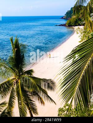 Couple of men and woman on the beach of Koh kradan Island Southern Thailand Stock Photo