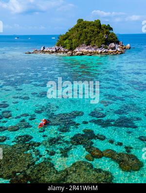 Couple with a kayak on a small Island in front of the Island Ko Lipe Thailand Stock Photo