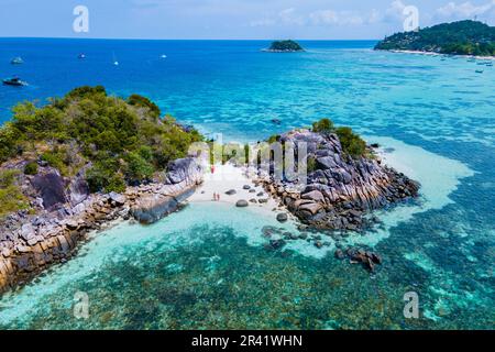 Couple with a kayak on a small Island in front of the Island Ko Lipe Thailand Stock Photo