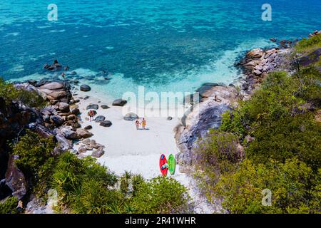 Couple with a kayak on a small Island in front of the Island Ko Lipe Thailand Stock Photo