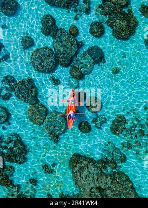 Couple with a kayak on a small Island in front of the Island Ko Lipe Thailand Stock Photo