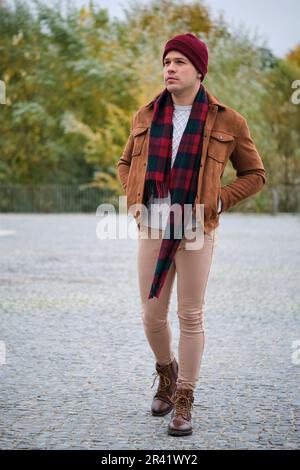 Latin young man wearing woolen hat and scarf during winter. Cold weather. Stock Photo