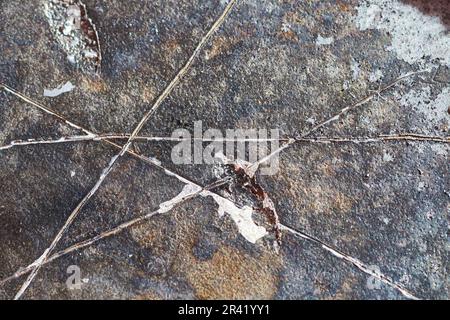 Clear white line scratches or cracks on burned slate gray hard drive CD disk background asset Stock Photo