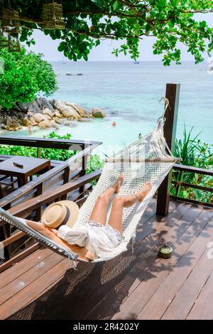 Asia women on vacation at Koh Lipe Island Thailand relaxing at a hammock Stock Photo