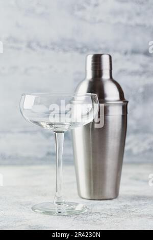 Empty champagne glass and metal shaker Stock Photo