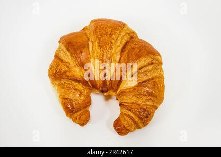 Top down view of fresh baked crescent shaped croissant on white background Stock Photo