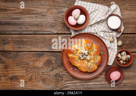 Composition with tasty Italian Easter bread, eggs and milk on wooden background Stock Photo