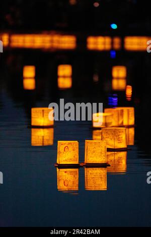 Asset background of golden lanterns on calm pond Stock Photo