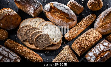 Assorted bakery products including loafs of bread and rolls Stock Photo