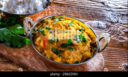 Curry chicken with rice served in original indian karahi pots. Stock Photo