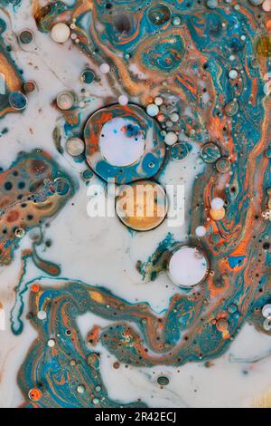 Marble like surface in abstract background asset made from oil and blue gold white and orange acrylic paints Stock Photo