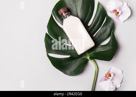 Coconut Oil or Cream, tropical leaves and flowers. Natural beauty spa product concept Stock Photo