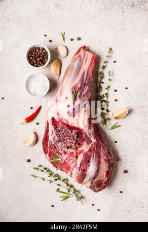 Raw fresh Lamb Meat shank and seasonings on gray concrete background Stock Photo