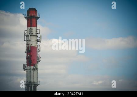 High heating plant chimney with antennas Stock Photo