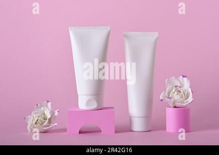 Beauty natural skincare product mock up. Cream tubes and flowers on different geometric podiums. Body Skincare products presenta Stock Photo
