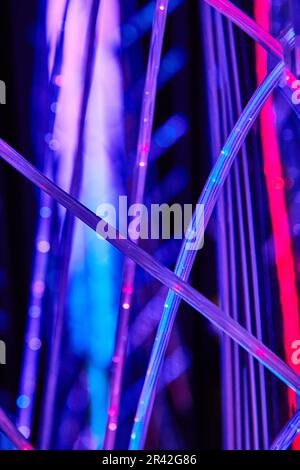 Techno cables and wires with vibrant purple neon LED lights Stock Photo