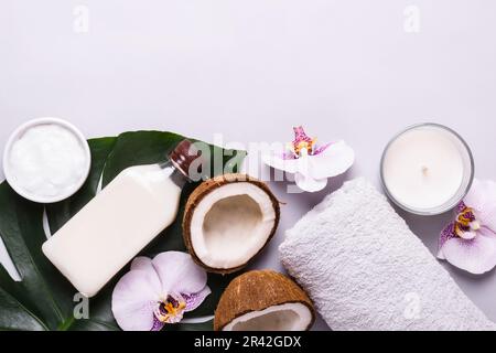 Coconut cosmetic product, tropical leaves and flowers. Natural spa concept Stock Photo