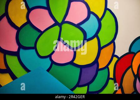 Abstract balloons or scales as wall art with green blue yellow pink purple and orange blobs with blue triangle at Otherworld in Ohio Stock Photo