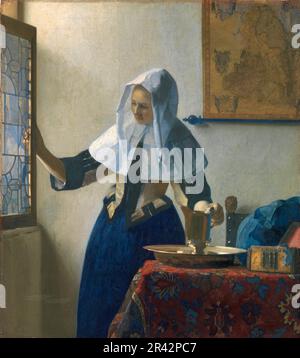 Young Woman with a Water Pitcher painted by the Dutch Golden Age painter Johannes Vermeer in  1662-1665 Stock Photo