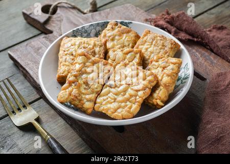 Fried Tempeh or Tempe is a traditional Malay dish snack popular in Malaysian, Indonesian, and Singapore Stock Photo