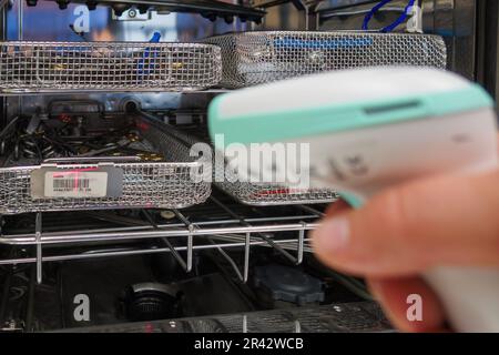 an instrument sieve is scanned in a sterilization department Stock Photo
