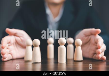 Manager chooses and hiring team for business success. HR manager hand or Employer chooses takes in hand employee. Leader stands out from crowd. Lookin Stock Photo