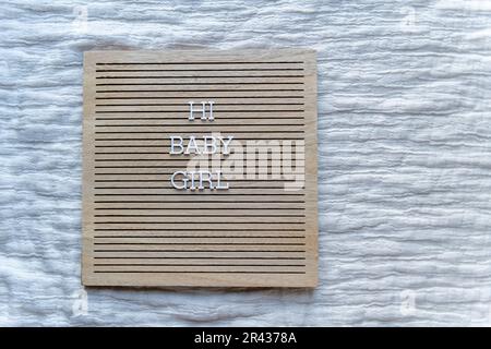 Hi baby girl wooden brown letter board with white letters Stock Photo