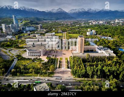 Aerial drone view panorama of Kazgu university educational center square near timiryazev street with cars and buildings around in Almaty city against Stock Photo