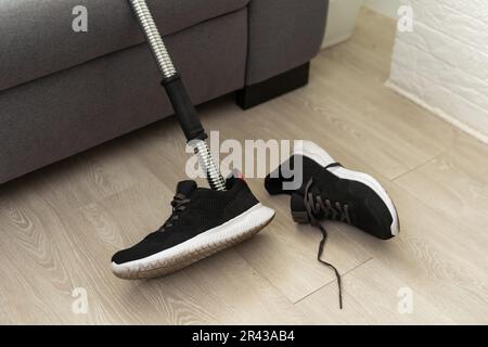 High angle background of disassembled prosthetic leg and foot on table in orthopedic equipment shop, disability concept Stock Photo