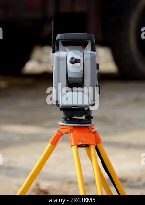Theodolite on a tripod for surveying on a construction site Stock Photo