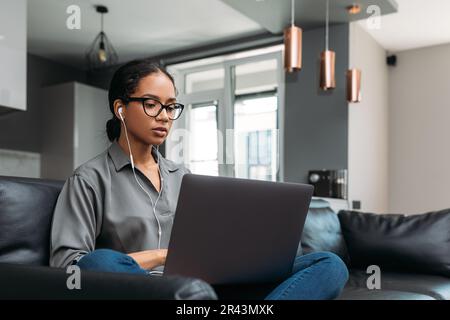 Young female in eyeglasses working from home Stock Photo