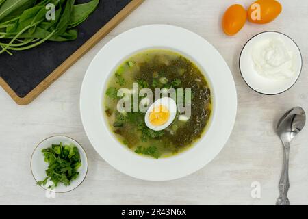 Green Sorrel soup made from broth, sorrel leaves, eggs (hard boiled), potatoes, carrots, parsley root. Polish, Ukrainian, Belarusian, Russian, Jewish Stock Photo