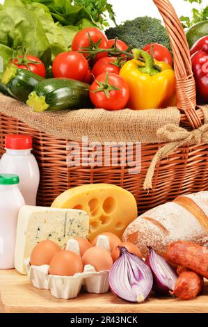 Assorted grocery products including vegetables fruits wine bread dairy and meat Stock Photo