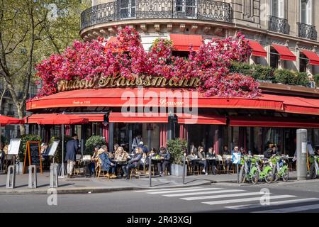 Flower-decorated facade at the Triadou Haussmann sidewalk cafe, Boulevard Haussmann, Paris, France Stock Photo