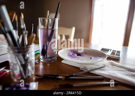 Art supplies and brushes on table top Stock Photo