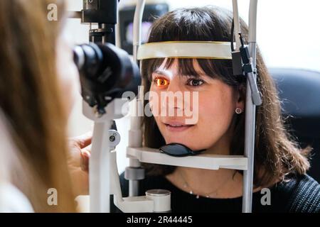 oculist looking at the eye with a machine to a patient Stock Photo