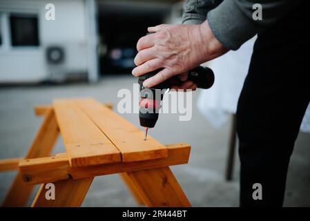 Carpenter using with wlectric drill closeup Stock Photo