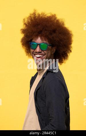 Side view of a isolated happy and satisfied young man with curly hair Stock Photo