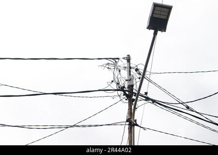 electric pole with messy wires isolated on white background Stock Photo
