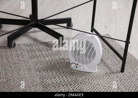 Modern electric fan heater on floor indoors Stock Photo