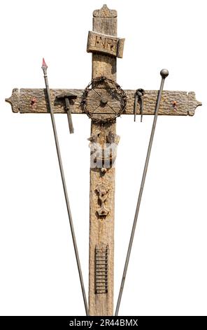 Old wooden cross with the symbols of the Passion of Jesus Christ, pincer, ladder, hammer, chalice, spear, crown of thorns, rooster, nails and text INR Stock Photo